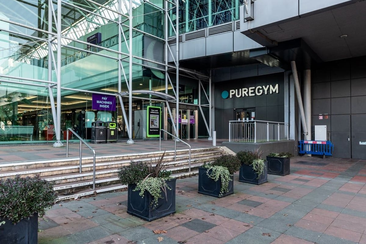 PureGym Hatfield: Exterior facade of gym with steps, landscaping, and signage.