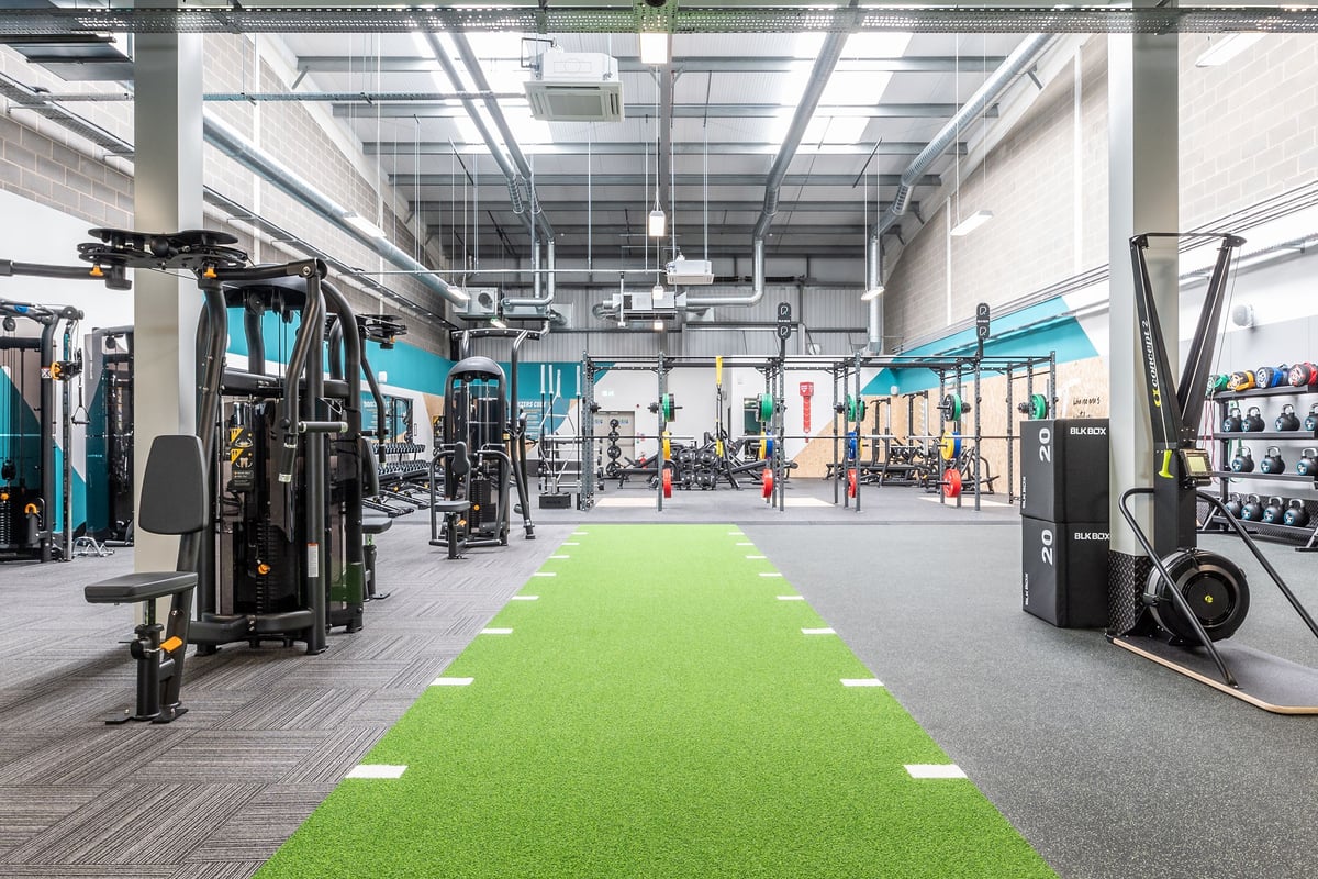 PureGym Sittingbourne: Weight machines, resistance bands, green turf area, free weights, mirrored walls.