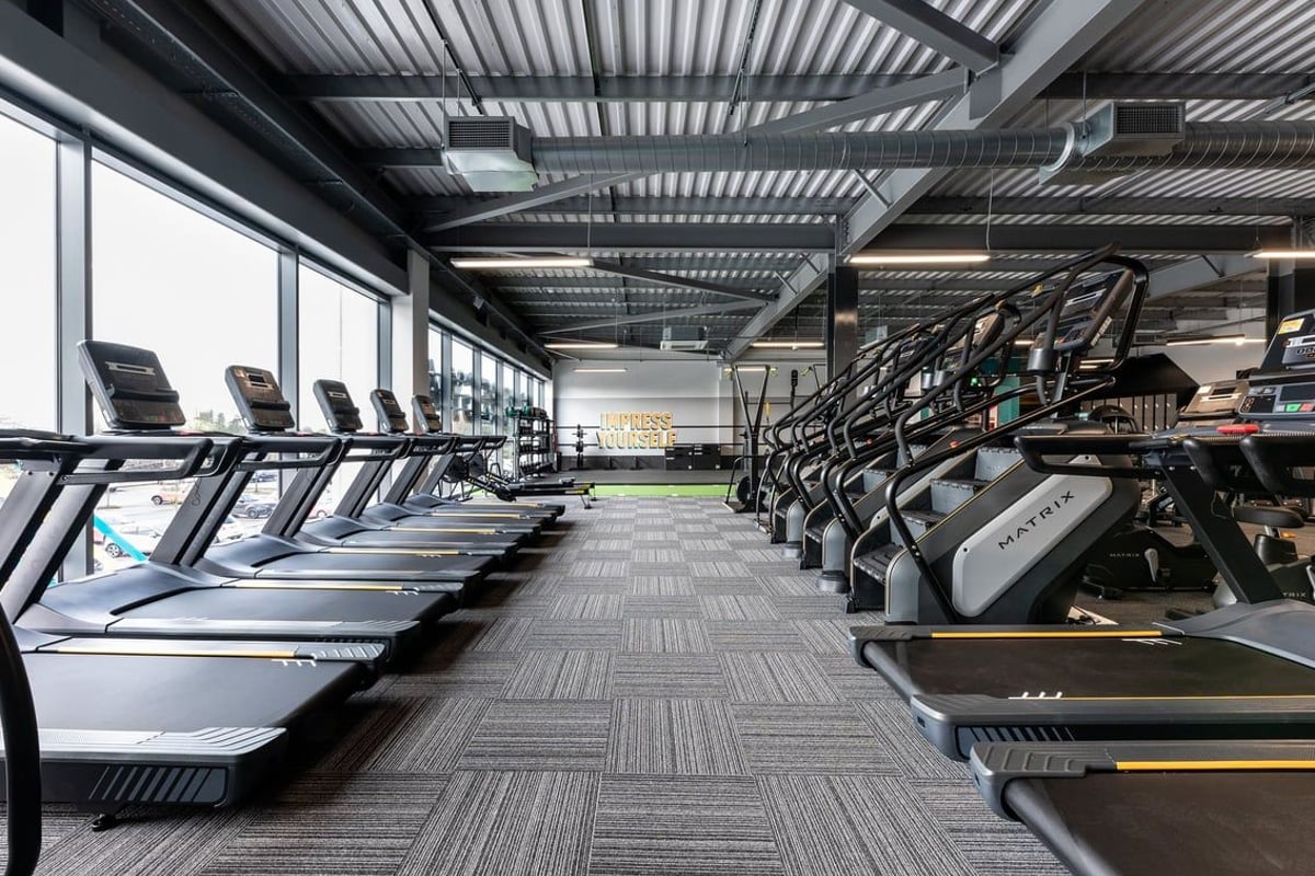 PureGym Yate: Rows of treadmills, stairmasters, ceiling with metal framing visible.