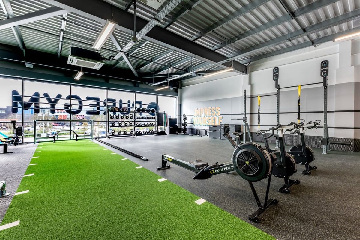 PureGym Yate: Weight sleds, turf area, squat racks, plyo boxes, wall balls inside a functional training facility.