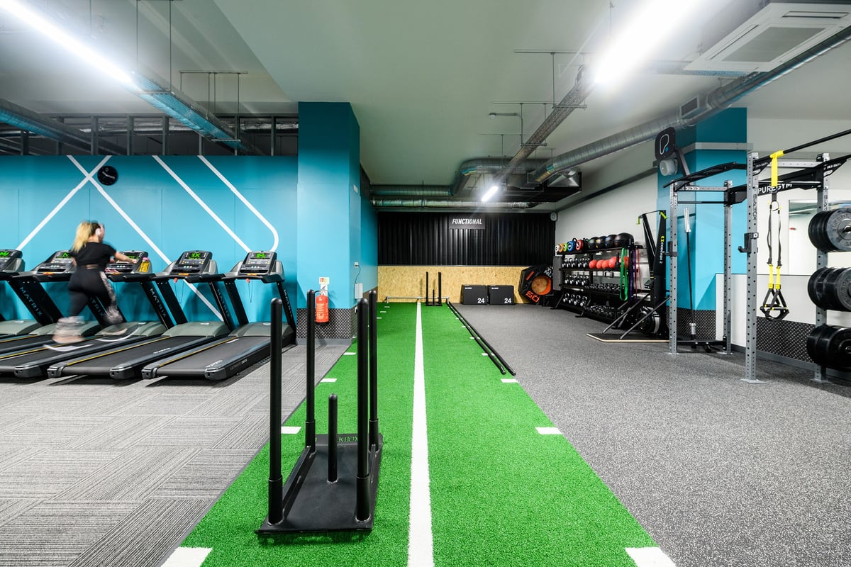 PureGym London Whitechapel: Treadmills, turf track, weight racks, resistance machines in a modern fitness studio.