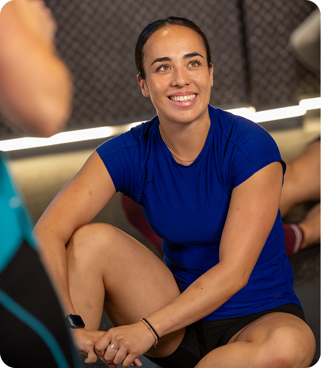 Feel PureGym Good: female member sitting on the floor and smiling in a class