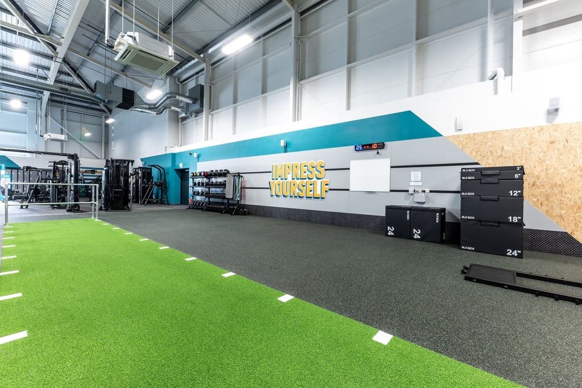 PureGym Durham City Retail Park: Indoor turf area, storage lockers, and self-service checkout kiosks.