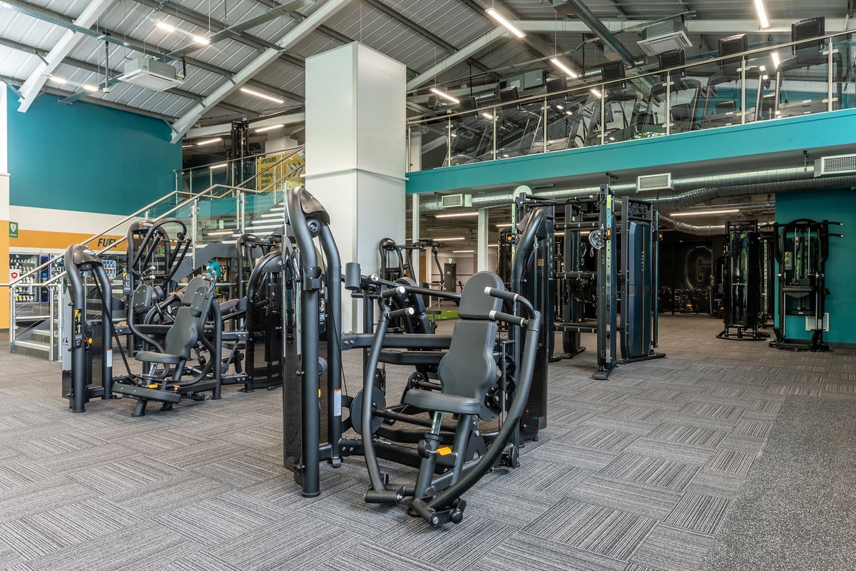 PureGym Bath Victoria Park: Weight machines, resistance equipment, and rubberized flooring in a spacious gym facility.
