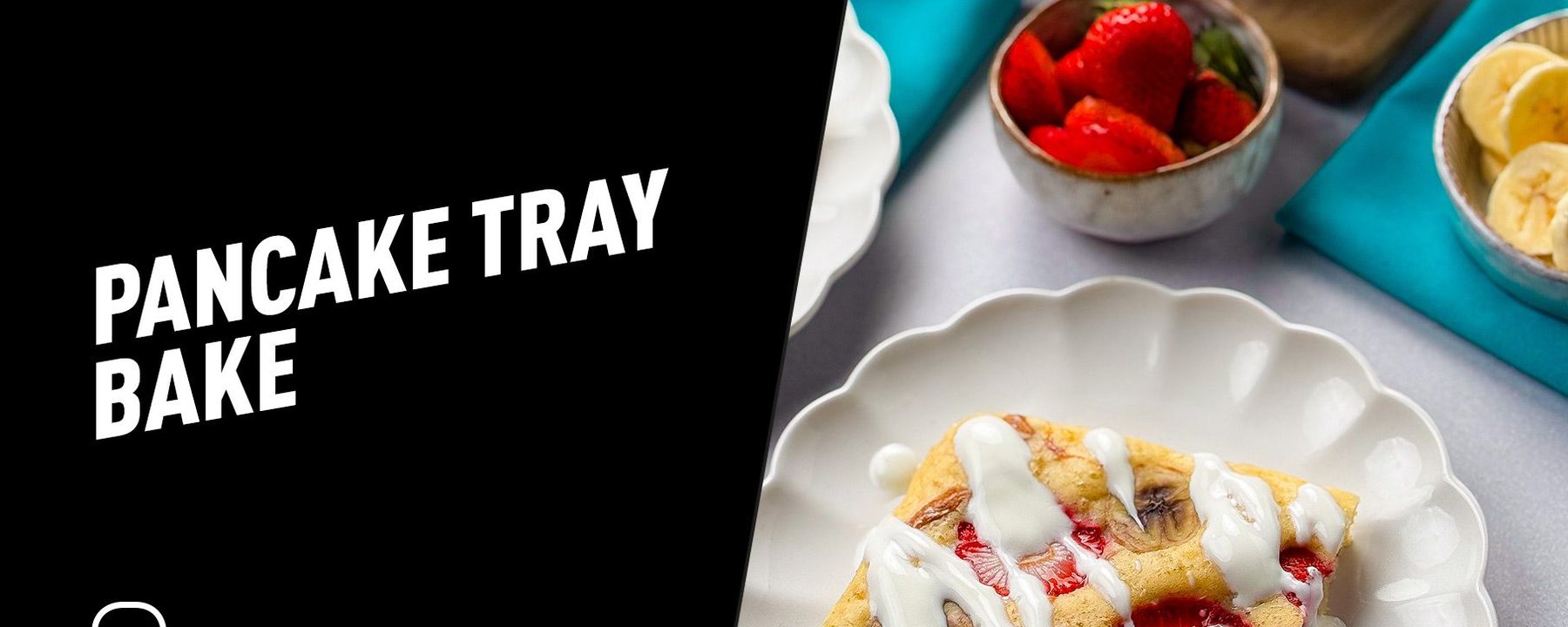 Square pancake slice with strawberries and banana drizzled with white sauce