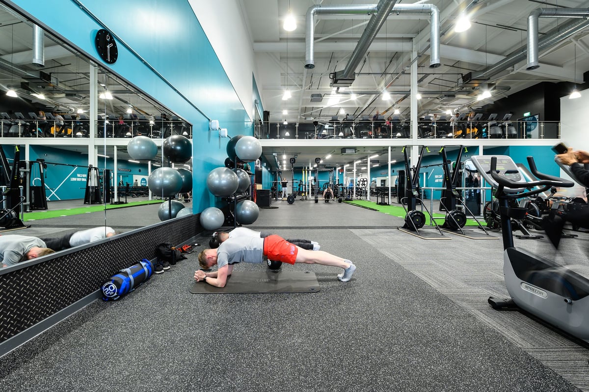 PureGym Exeter Bishops Court: Mirrored studio with resistance machines, free weights, medicine balls, and rubberized flooring.