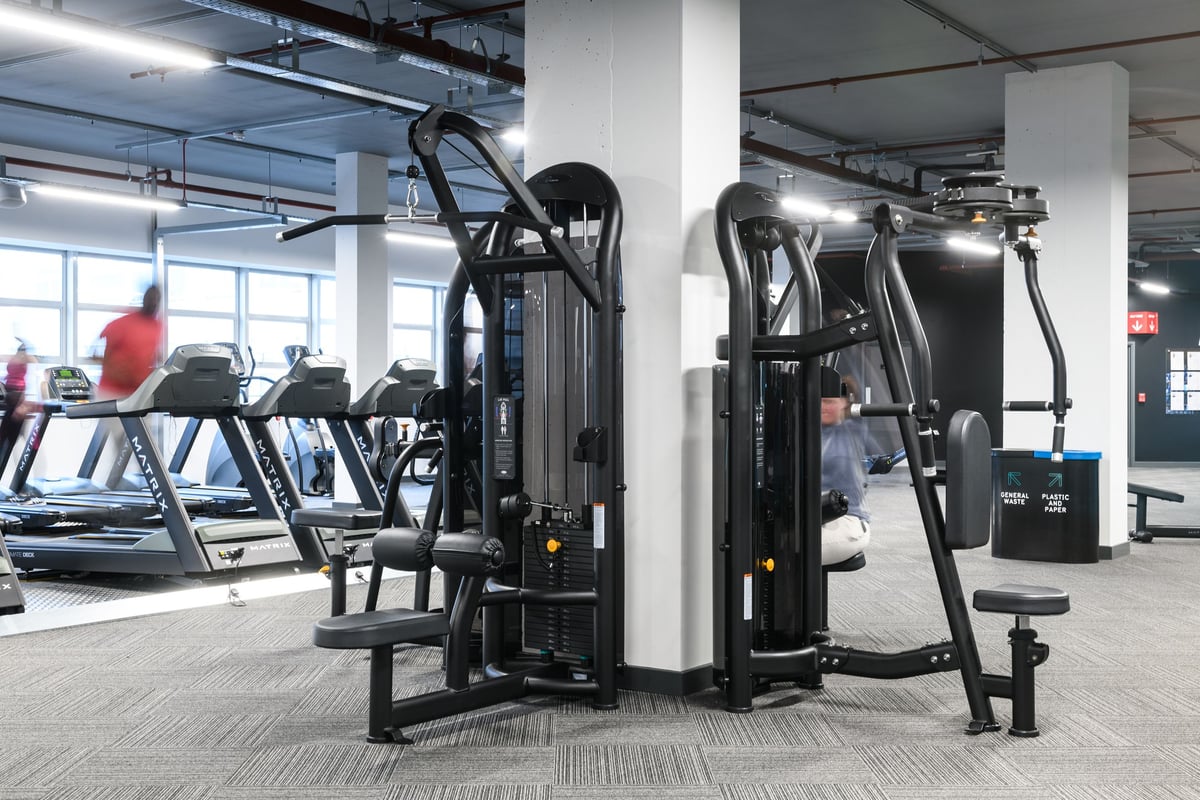 PureGym Basildon: Weight machines, resistance equipment, and cardio apparatus on gym floor.