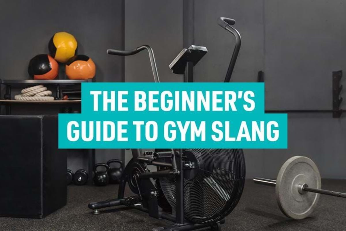 Exercise bike, weights, medicine balls, and a plyometric box in a gym room
