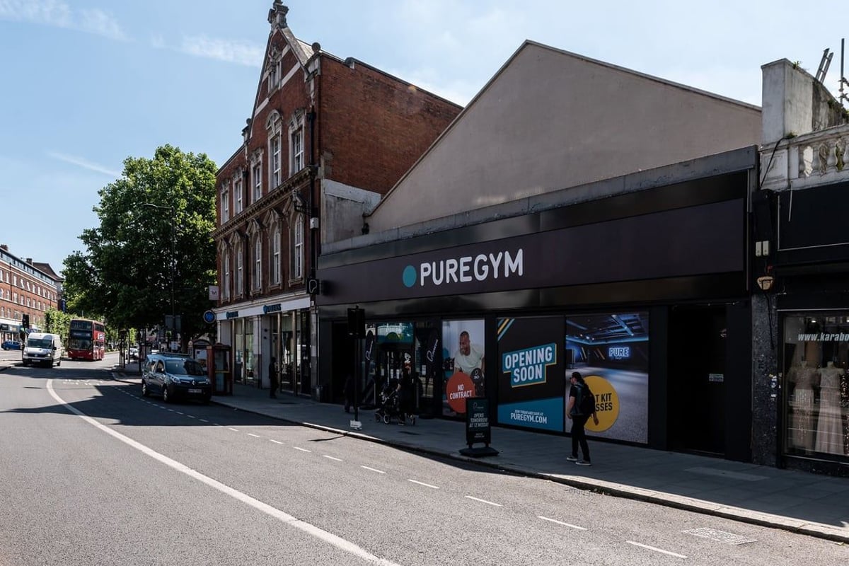 PureGym London Streatham: Gym exterior with red brick facade, 'PUREGYM' signage and people walking outside.