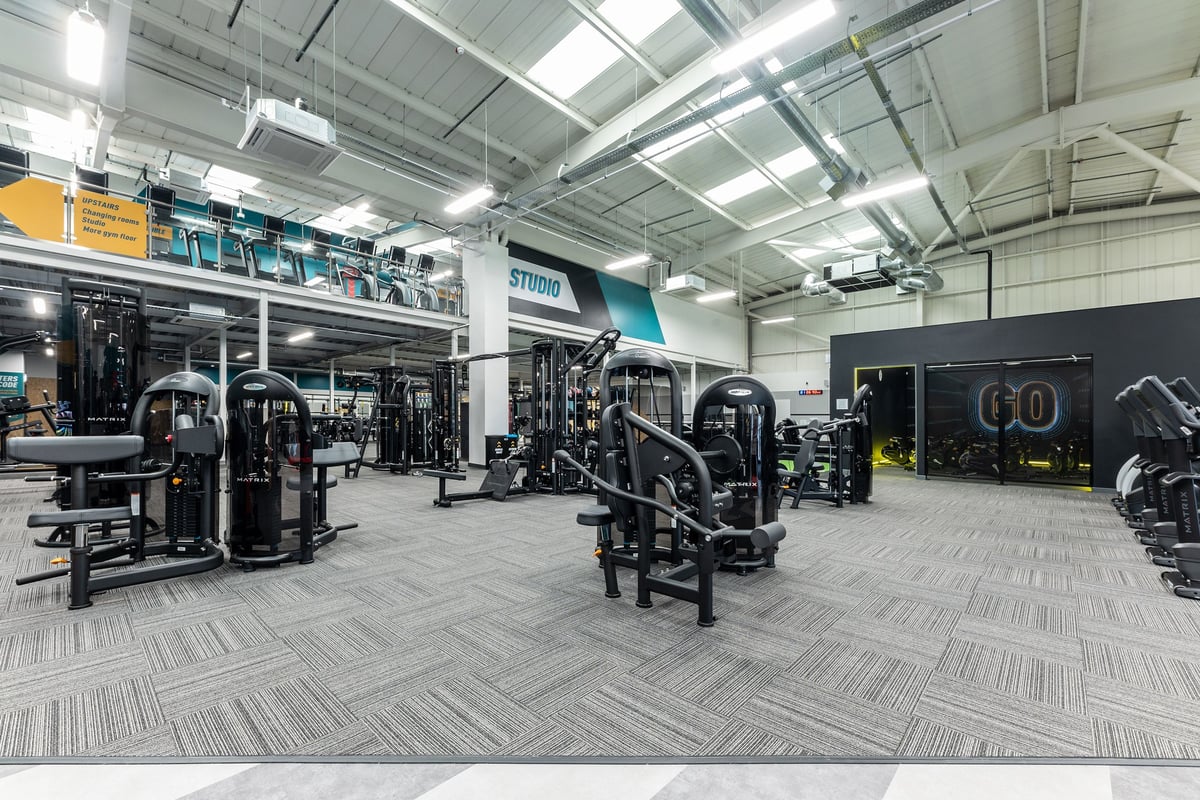 PureGym Eastbourne: Resistance machines, free weights, benches, and rubberized flooring in a gym studio.