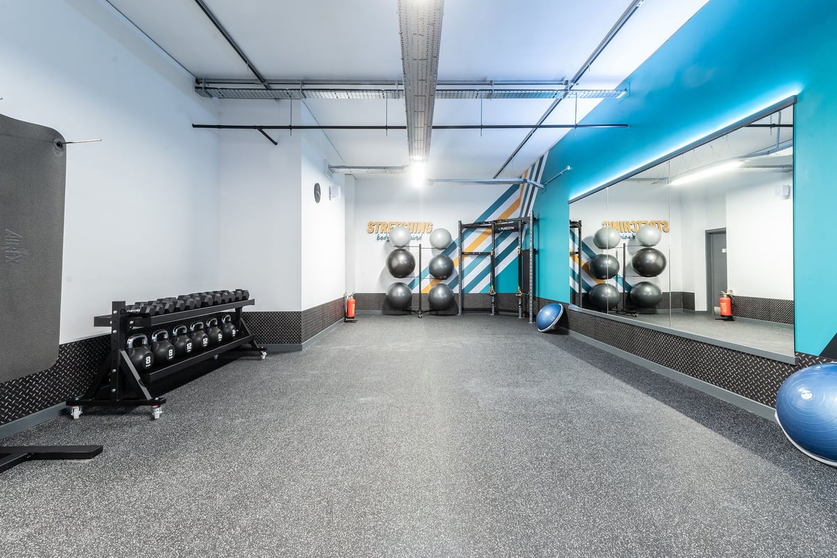 PureGym London Crouch End: Gym studio with weight benches, resistance machines, exercise balls, and rubberized flooring.
