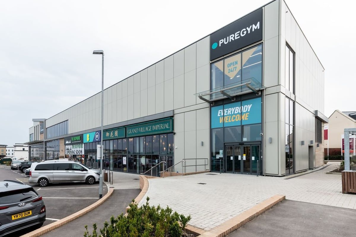 PureGym Bicester: Exterior of a gym facility showing signage and parking area.
