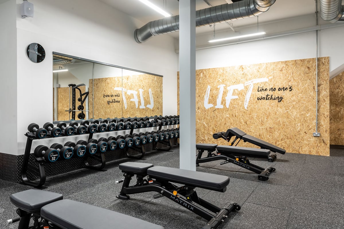 PureGym Chippenham: Rows of dumbbell racks and weight benches.