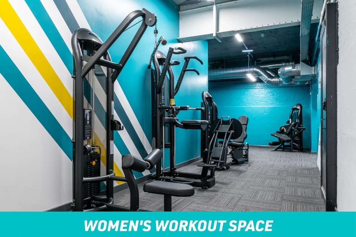 PureGym London Oval Women's Workout Space: pull down machine and assisted pull up machine