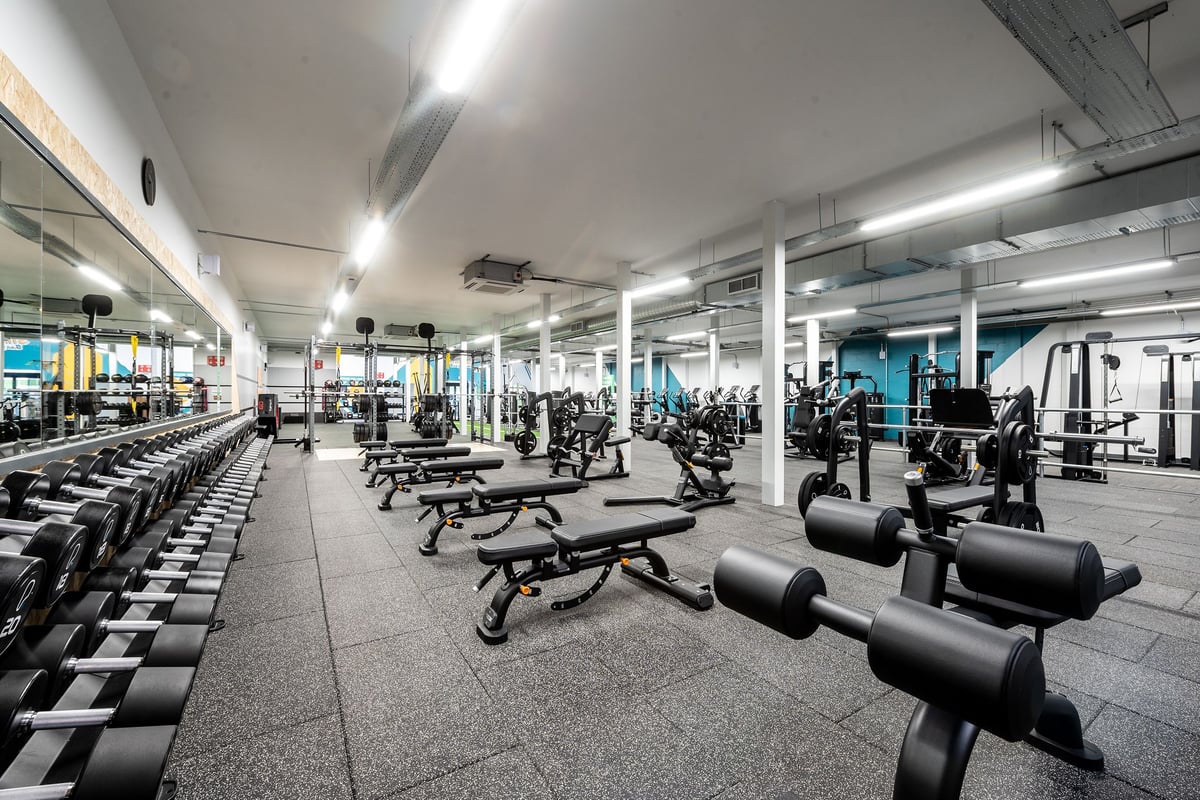 PureGym Inverness Inshes Retail Park: Gym with rows of weight machines, benches, free weights, and rubberized flooring.