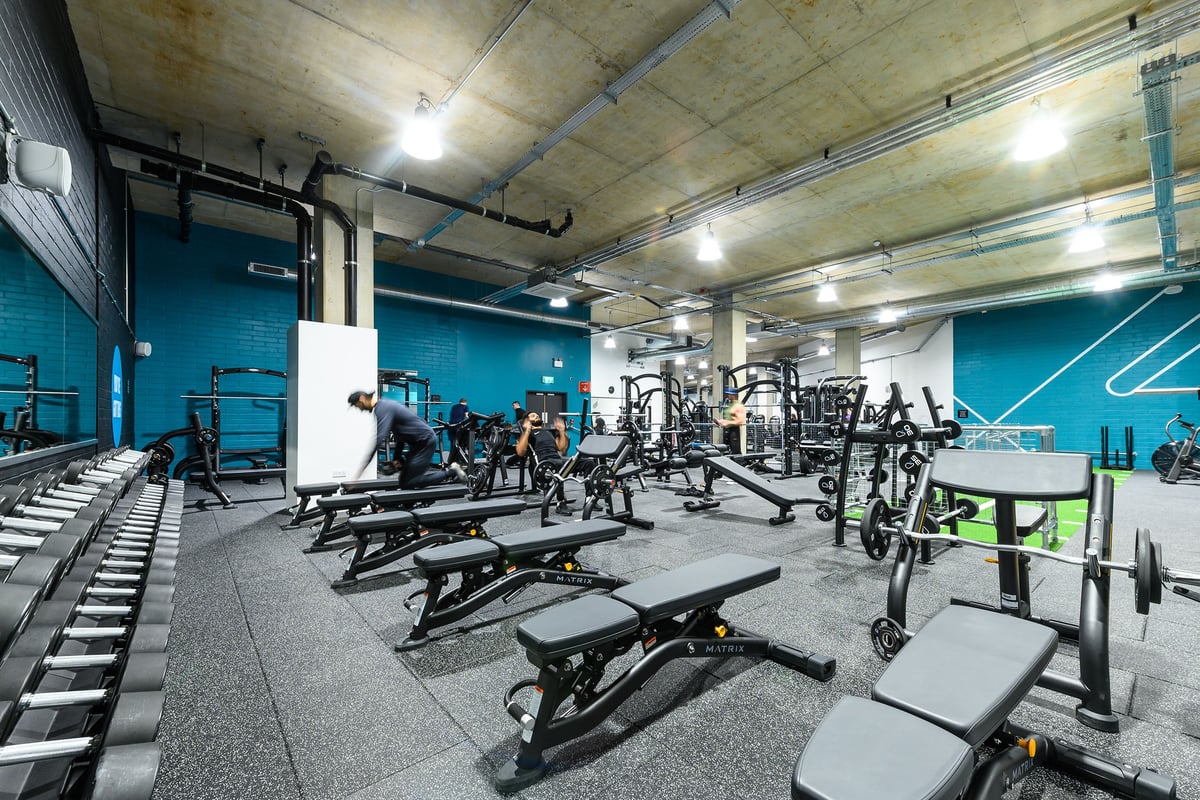 PureGym London Kidbrooke Village: Weight benches, squat racks, free weights, resistance machines on rubberized floor.