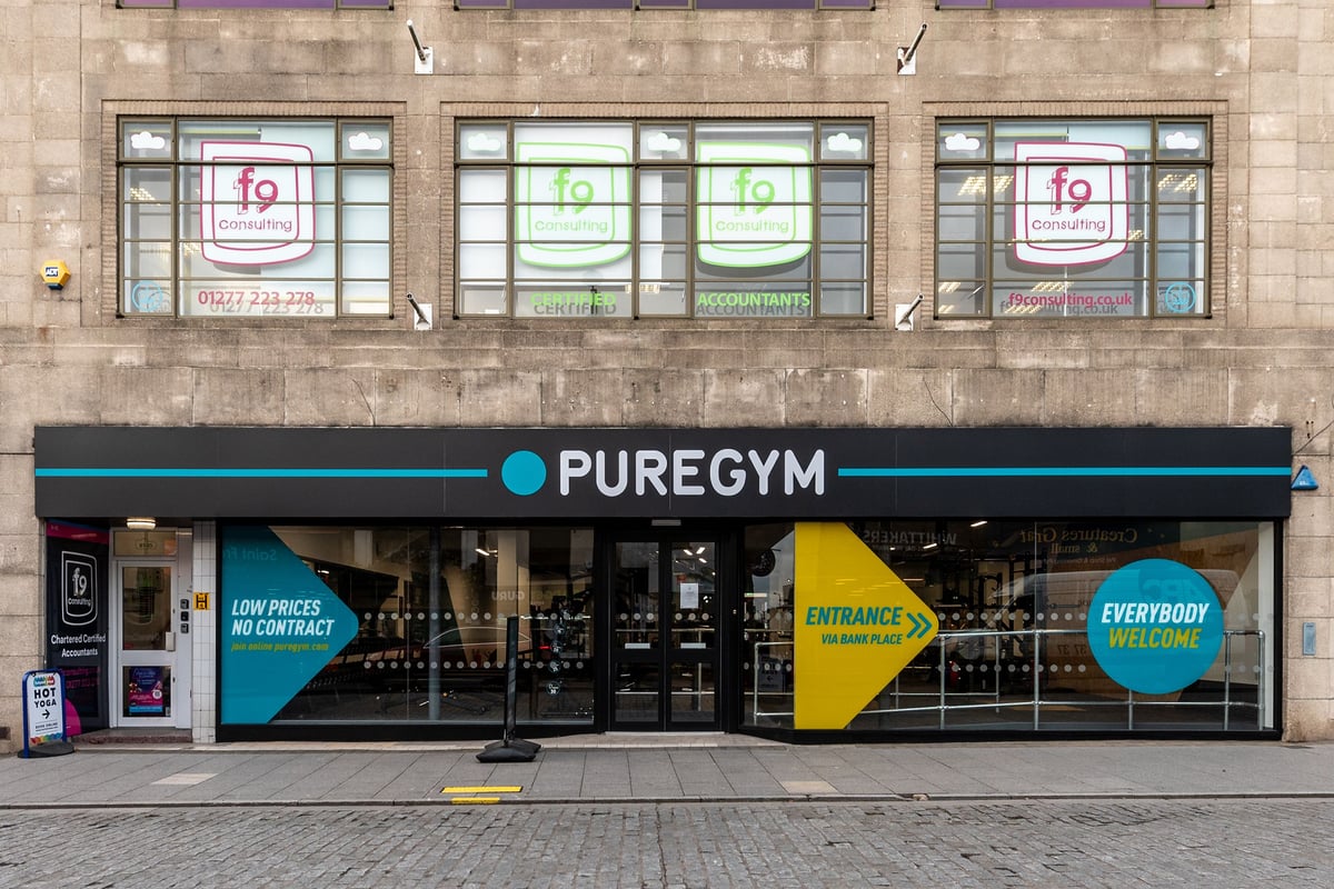 PureGym Brentwood: Gym storefront with teal and black branding, entrance signage highlighting low prices and accessibility.