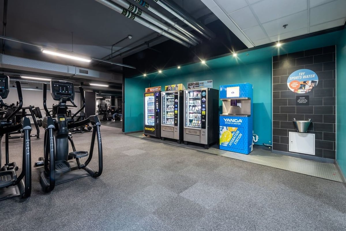 PureGym Liverpool Central: Treadmills, stationary bikes, weight racks, vending machines in a gym setting.