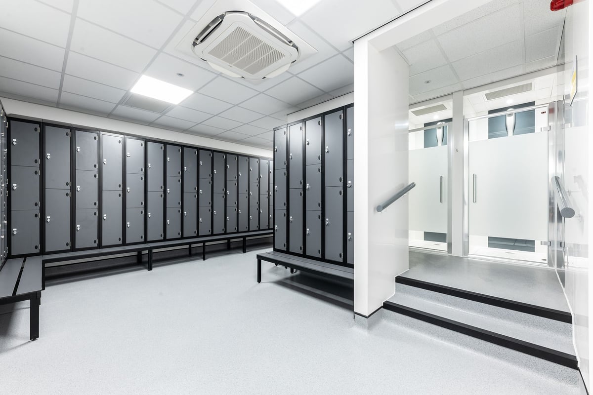 PureGym Bangor Wales: Rows of lockers, benches in a changing room setting.