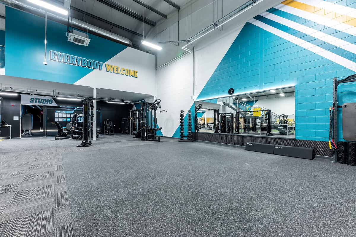PureGym Ballymena: Studio with weight racks, resistance machines, functional training area, and rubberized flooring.