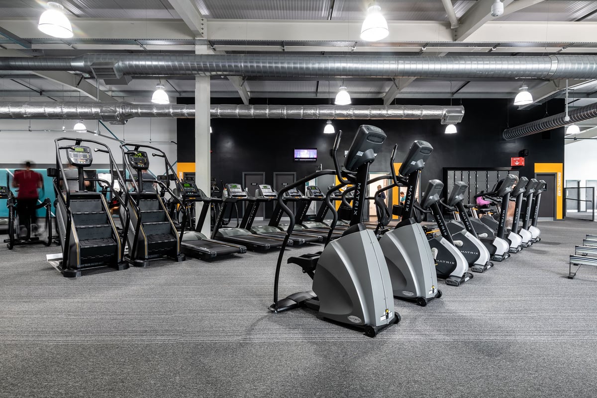 PureGym Portsmouth North Harbour: Rows of treadmills, ellipticals, and other cardio machines in a gym interior.