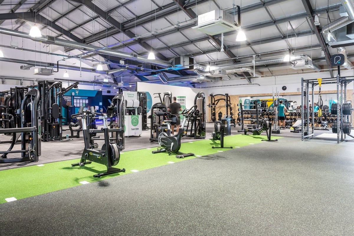 PureGym Stowmarket: Strength training equipment, free weights, resistance machines, and turf sections on rubberized flooring.