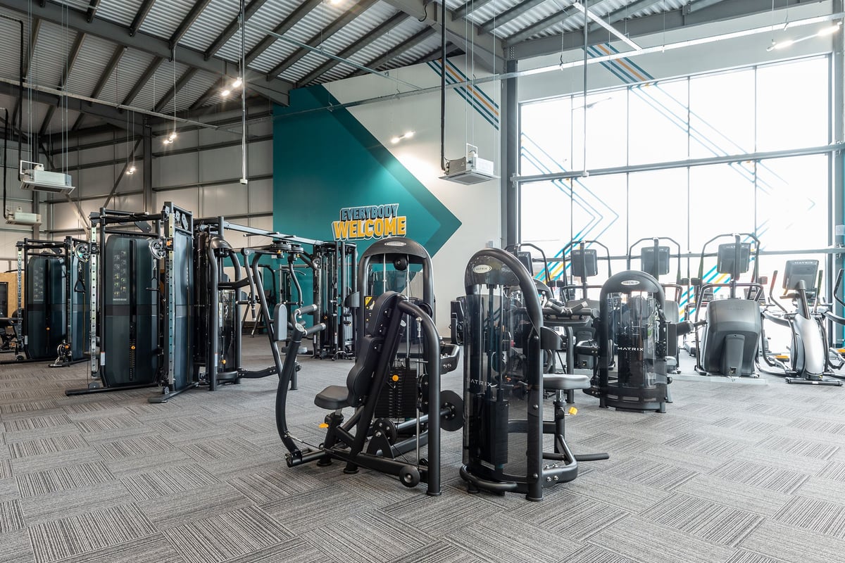 PureGym Nottingham West Bridgford: Weight machines, resistance equipment, and open floor space in a modern gym facility.