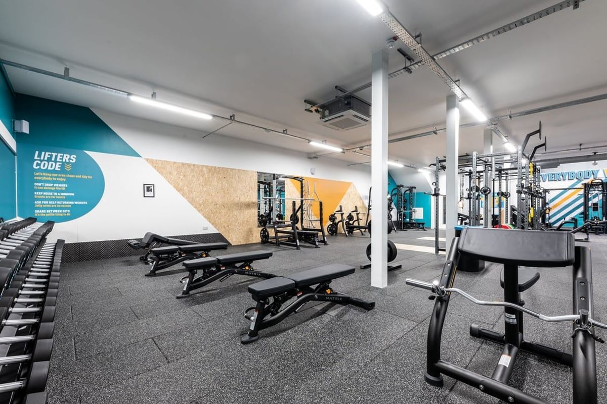 PureGym Heanor: Weight benches, resistance machines, free weights, and rubberized flooring inside a gym.