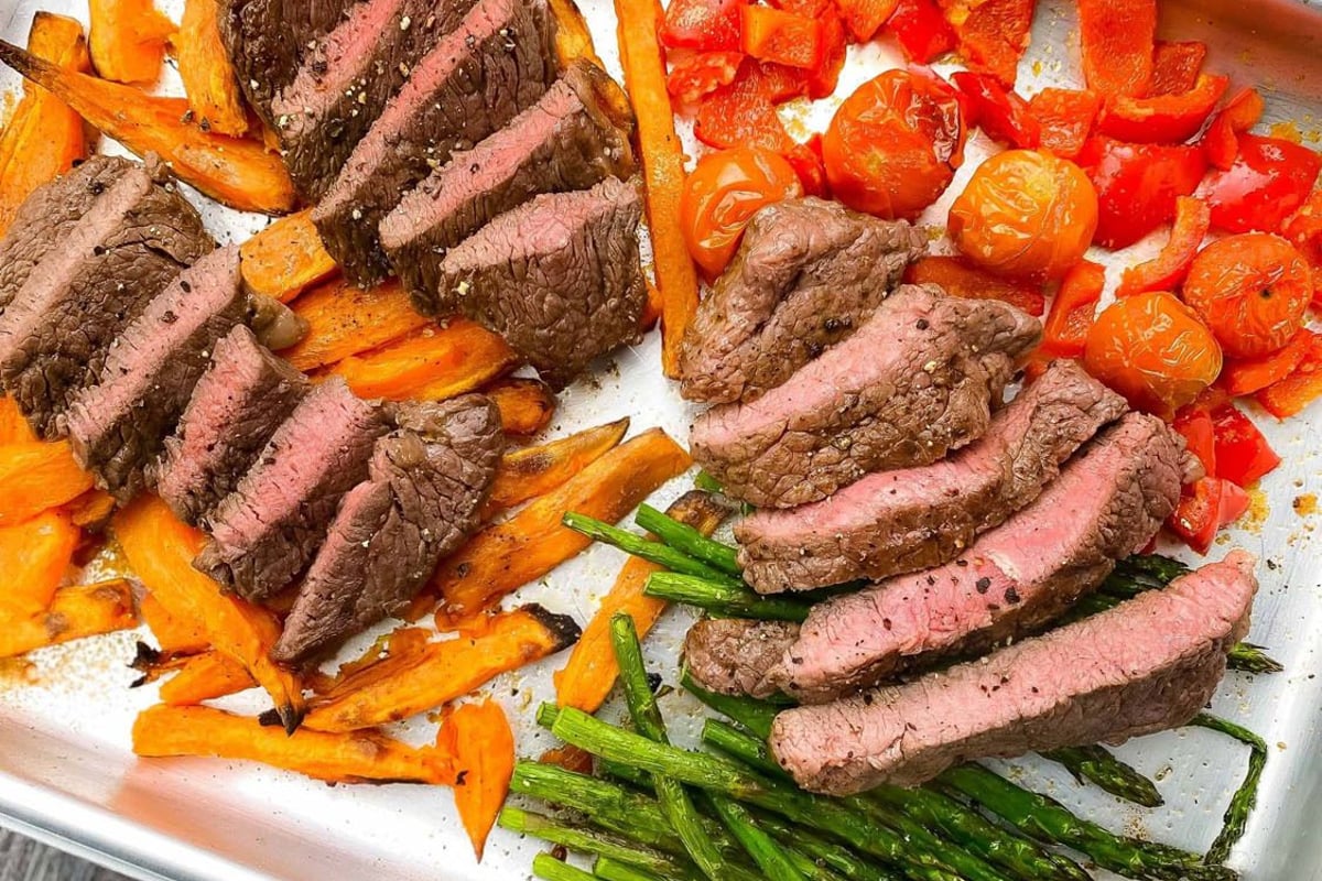 Sliced steak on a bed of vegetables