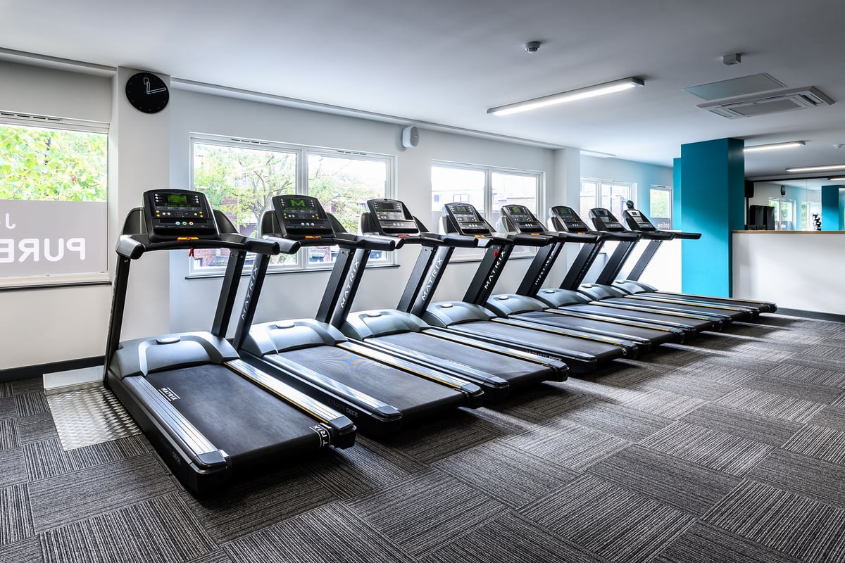 PureGym London Camberwell Southampton Way: Rows of modern treadmills lined up in a well-lit gym interior.