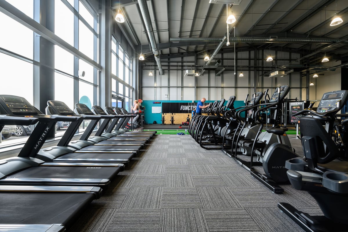 PureGym Maldon Blackwater Retail Park: Rows of treadmills, ellipticals, and exercise bikes in a bright gym studio.