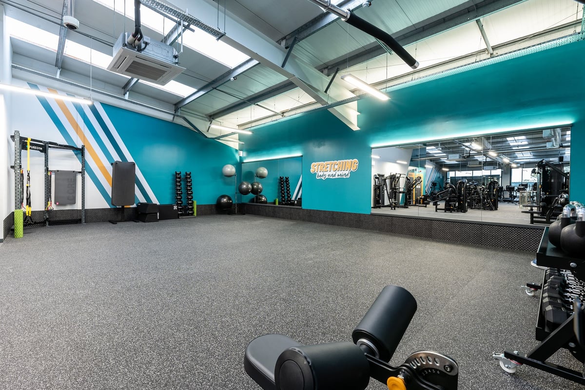 PureGym Solihull Sears Retail Park: Resistance machines, free weights, rubberized flooring in a teal and grey gym space.
