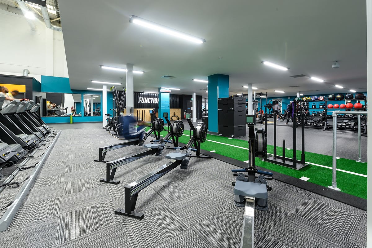 PureGym London Hayes: Treadmills, weight machines, free weights, benches, and resistance tubing in a colourful fitness studio.