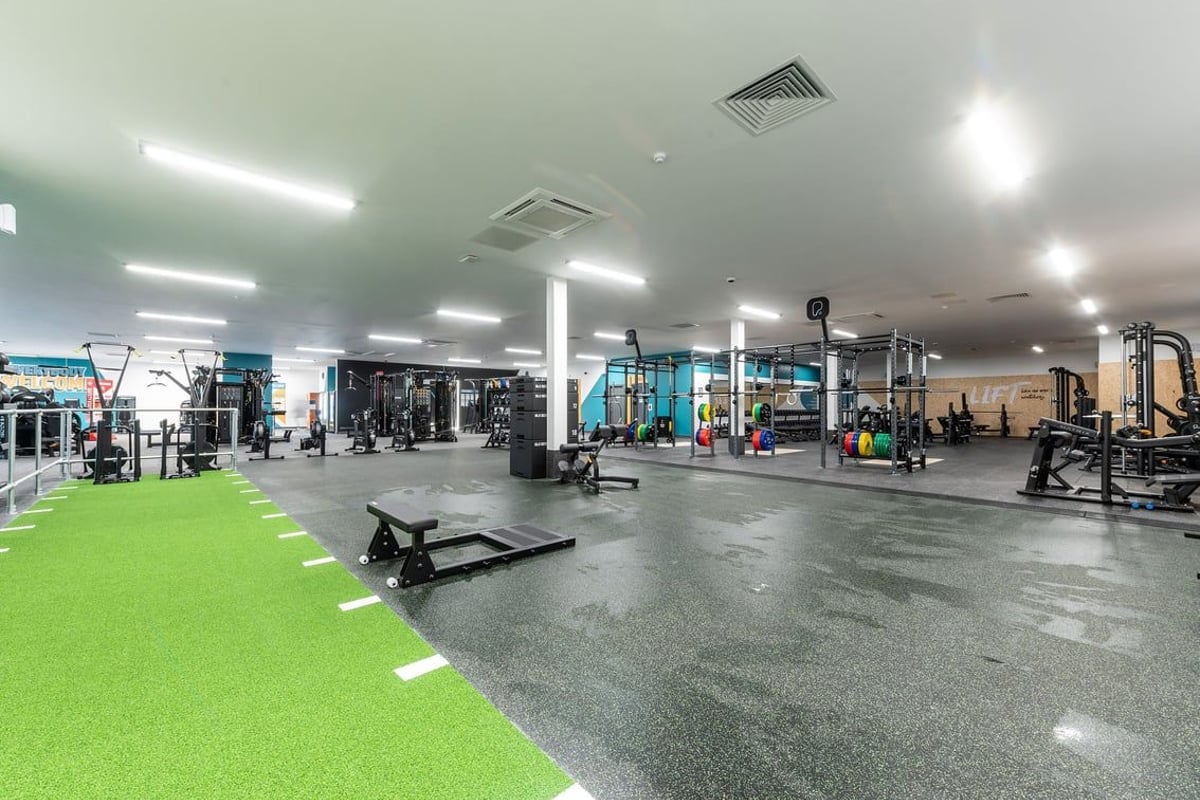 PureGym Knaesborough: Racks, benches, weights, turf area, and rubberized flooring of a well-equipped gym space.