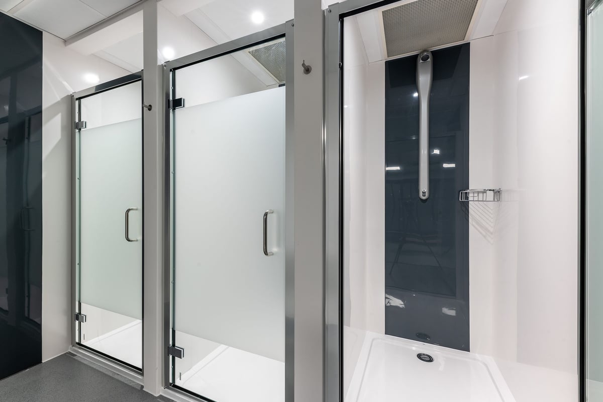 PureGym Coleraine: Shower stall area with glass panel doors and tiled floor.