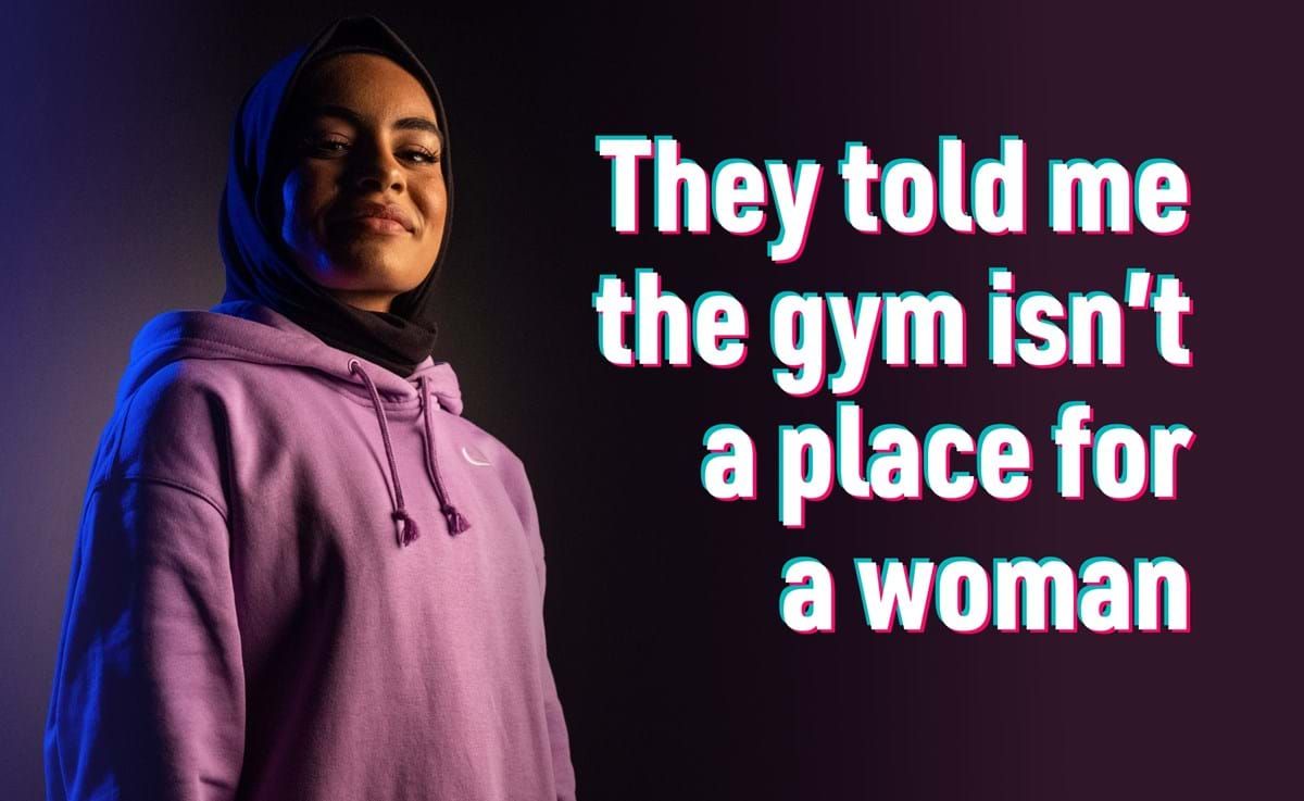 Woman in hijab and pink hoodie with text about gym not being for women