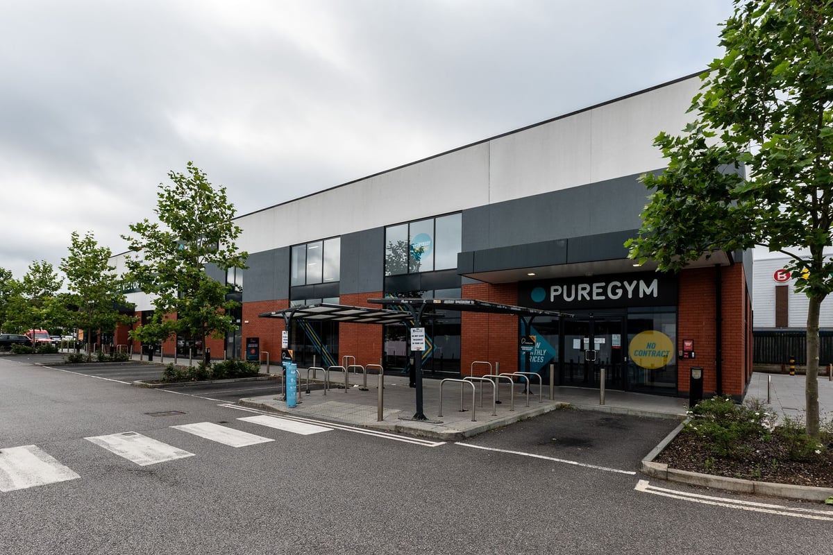 PureGym Reading Basingstoke Road: Exterior of gym building with trees, parking spaces, and PureGym signage.
