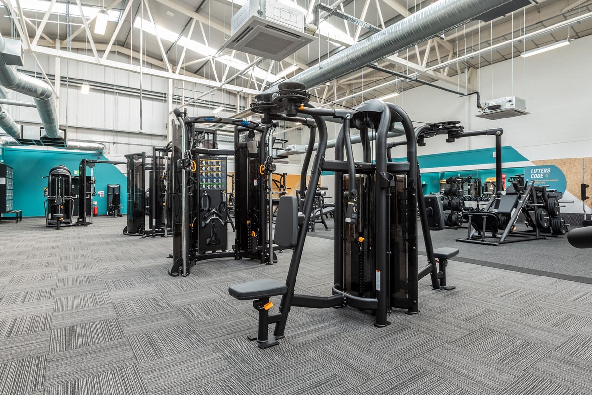 PureGym Bridgend: Resistance training machines, weight racks, benches, and rubberized flooring in a gym setting.