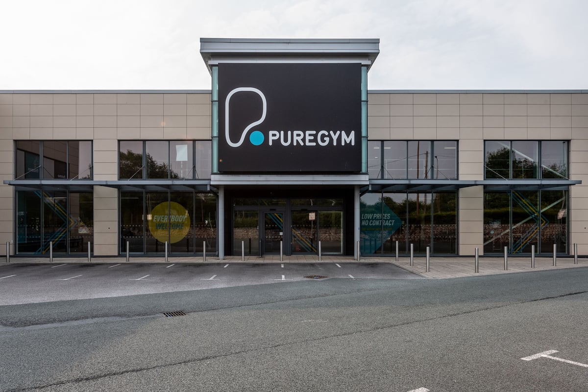 PureGym Wirral Bidston Moss: Commercial gym exterior with branding, glass facade and parking lot.