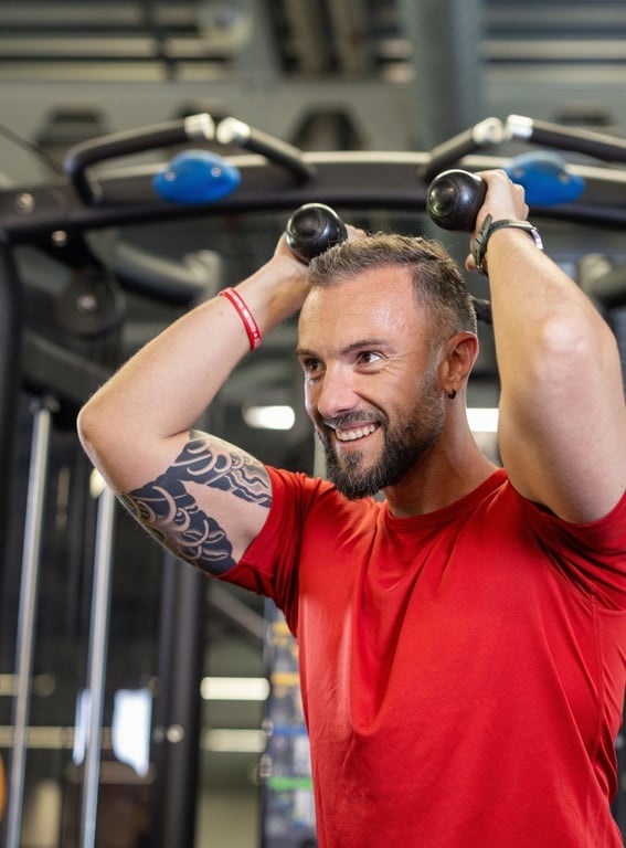 PureGym: a smiling male member working out
