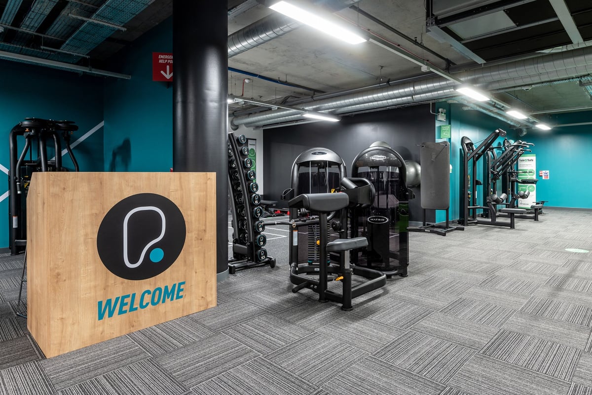 PureGym London Camberwell New Road: Gym studio with weightlifting racks, cable machines, and rubberized flooring.