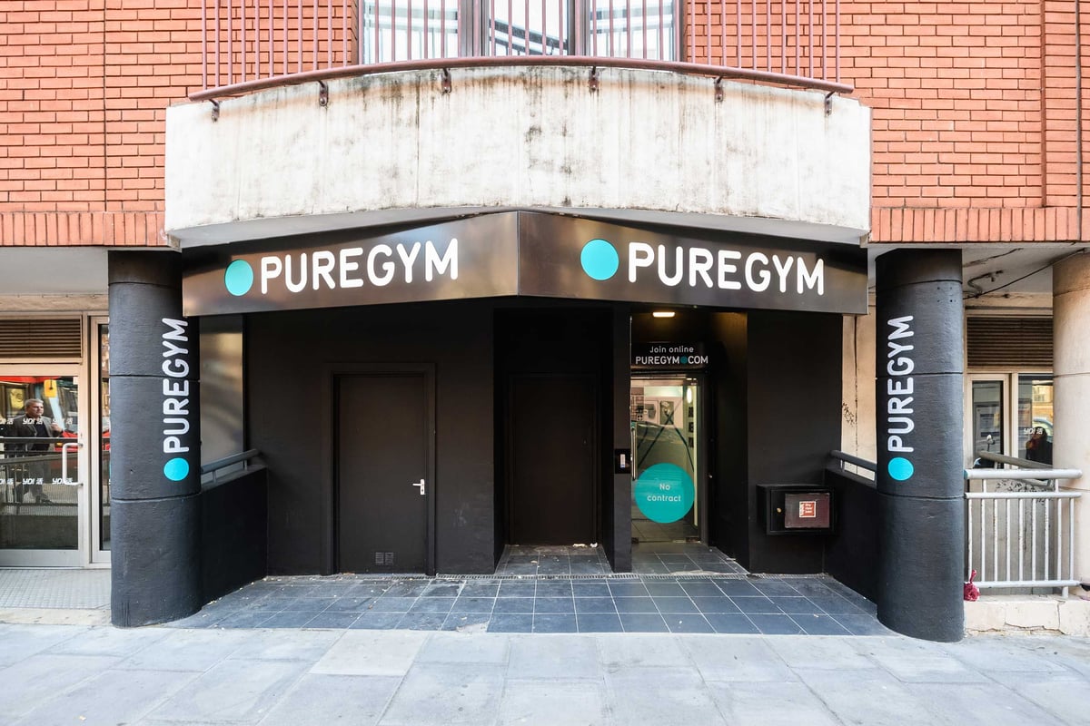 PureGym London Farringdon: Gym entrance in a redbrick building with PureGym signs.