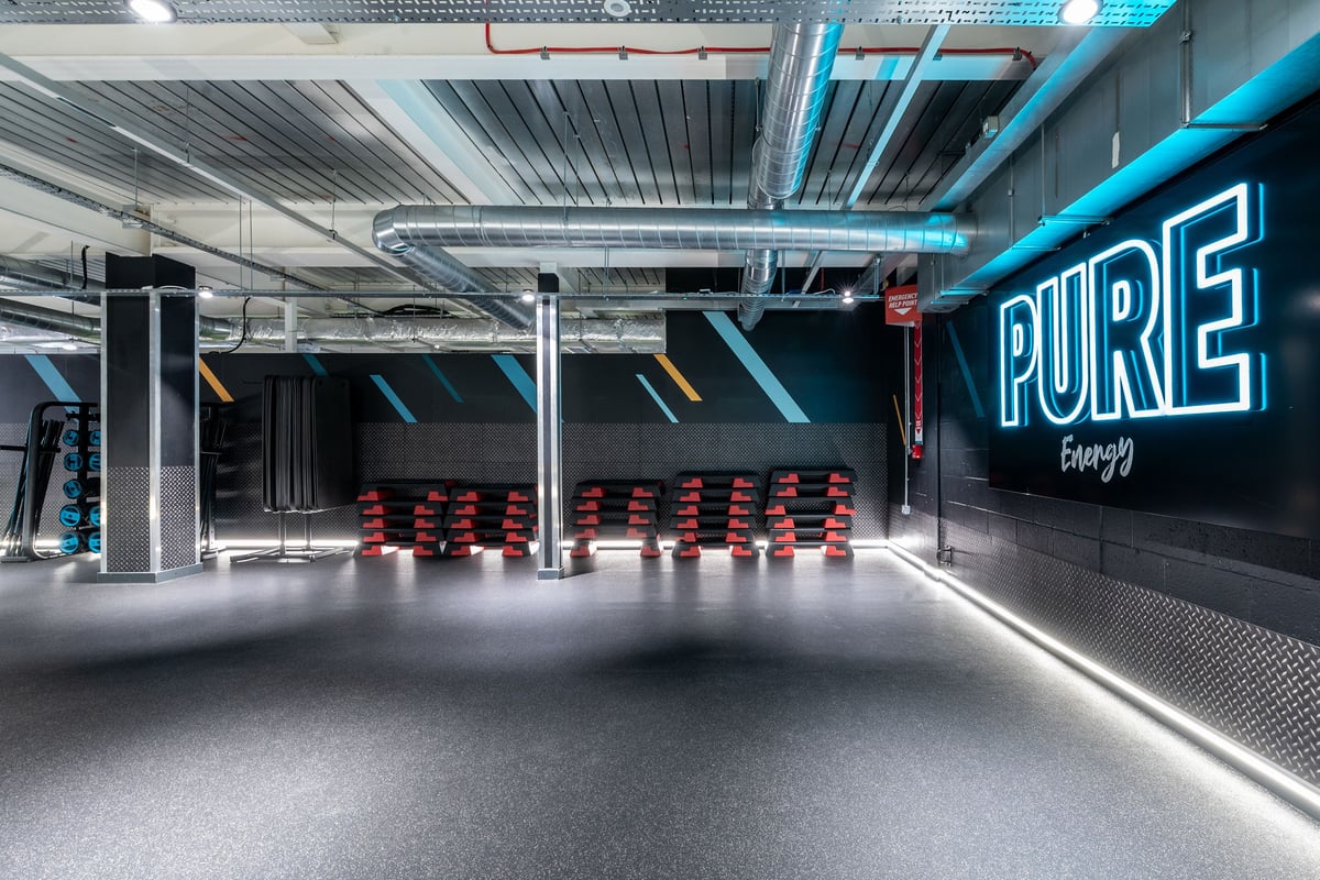 PureGym London Orpington Central: Free weight racks, rubberised flooring and neon 'PURE Energy' signage.
