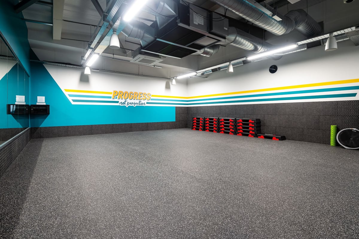 PureGym Linlithgow: Resistance machines, weights, floorspace with treadmills or cycle ergometers partially visible.