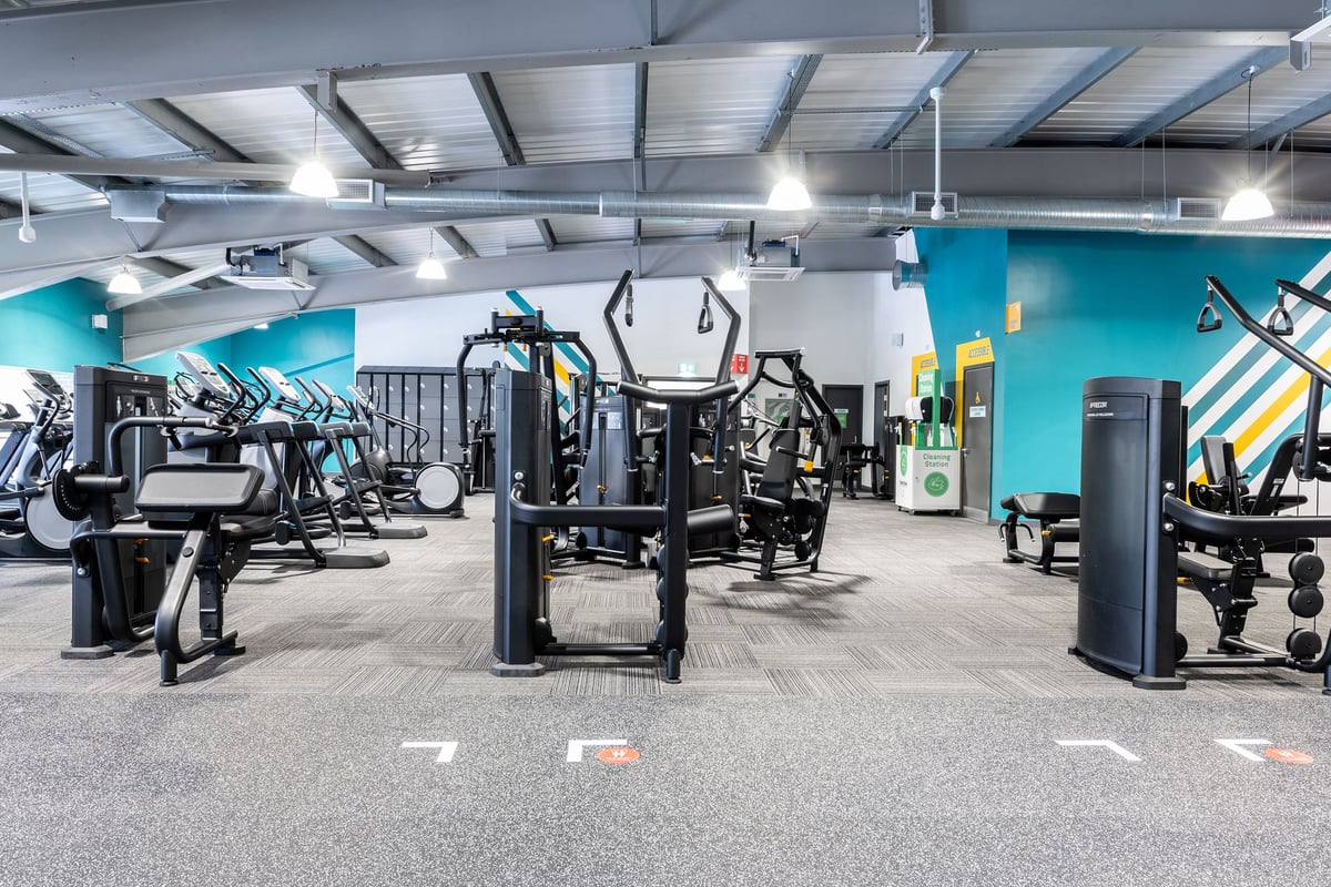 PureGym Bournemouth Mallard Road Retail Park: Gym floor with resistance machines and colourful accent walls.