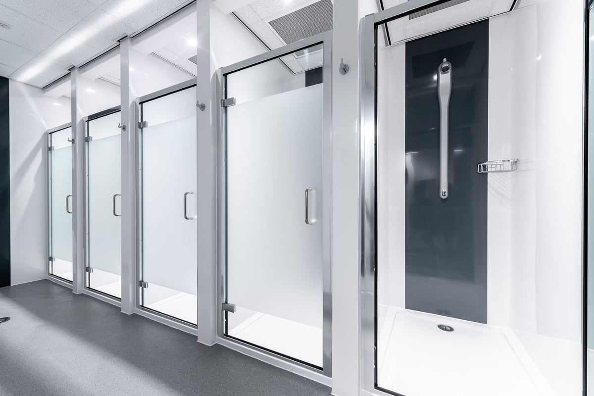 PureGym Reading Calcot: Glass-paneled doors in what appears to be changing or shower room facilities.