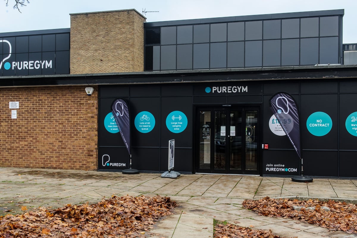 PureGym Bedford Heights: The exterior of a fitness center with signage and outdoor seating.