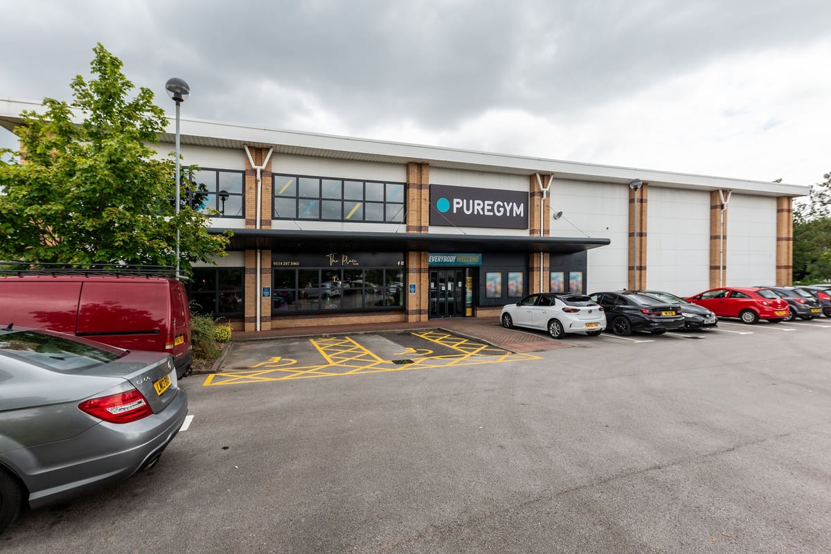 PureGym Sheffield Crystal Peaks: Gym exterior with signage, parking spaces, and various vehicles.