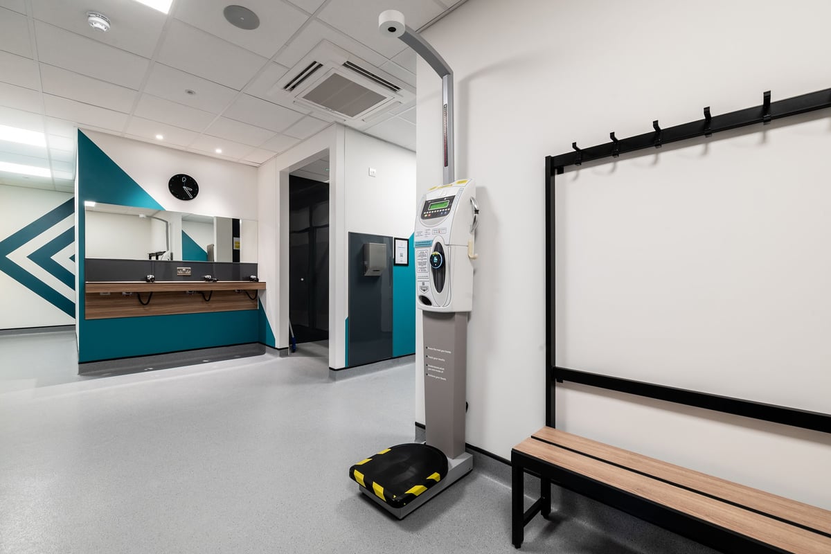 PureGym London Colney: changing room with bench and scales