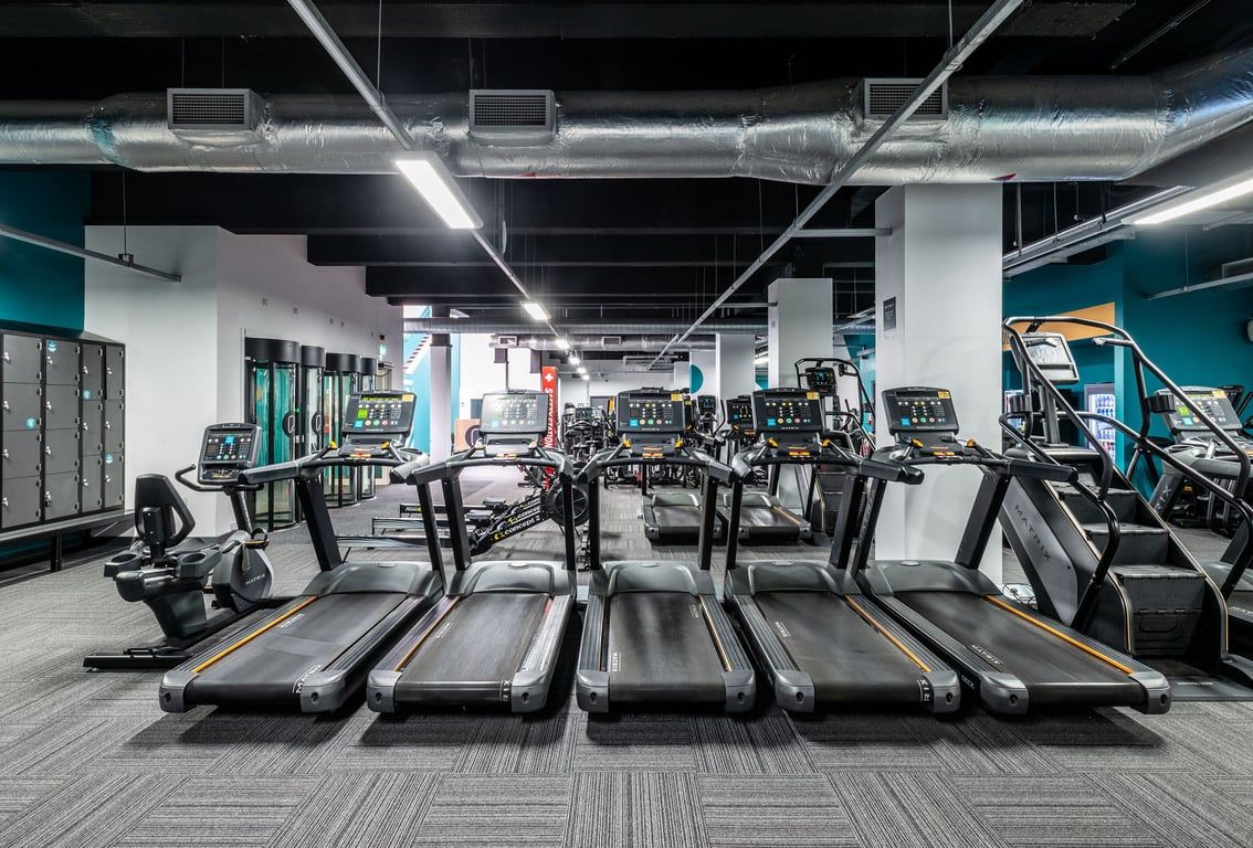 PureGym Manchester Market Street: Rows of treadmills, exercise bikes, and weight machines in a modern gym interior.